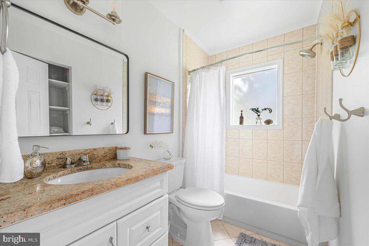 10112 Dallas Avenue Silver Spring, MD 20901 - Photo 12 of 32 a bathroom with a granite countertop sink toilet and shower