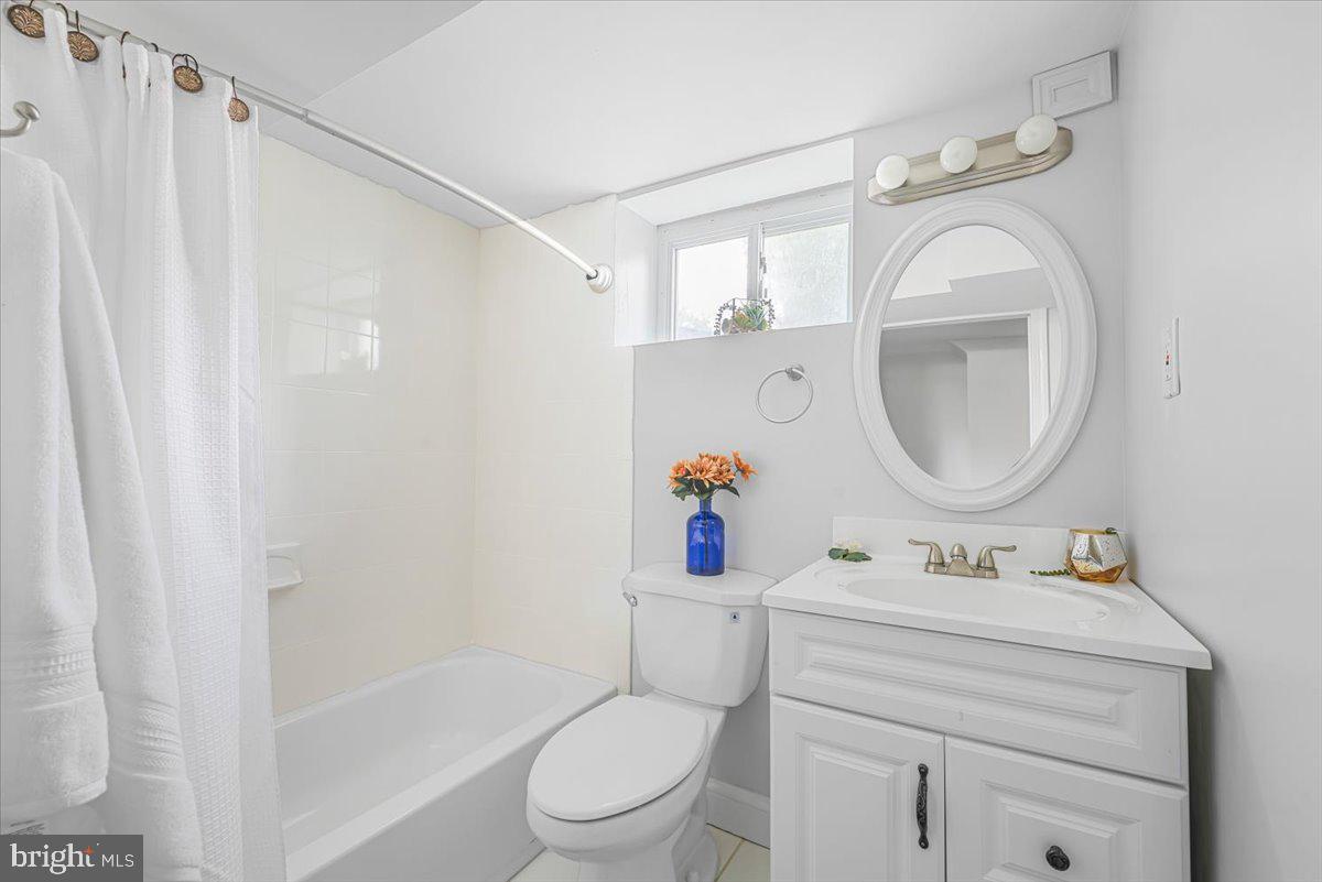 10112 Dallas Avenue Silver Spring, MD 20901 - Photo 23 of 32 a bathroom with a sink mirror vanity and toilet