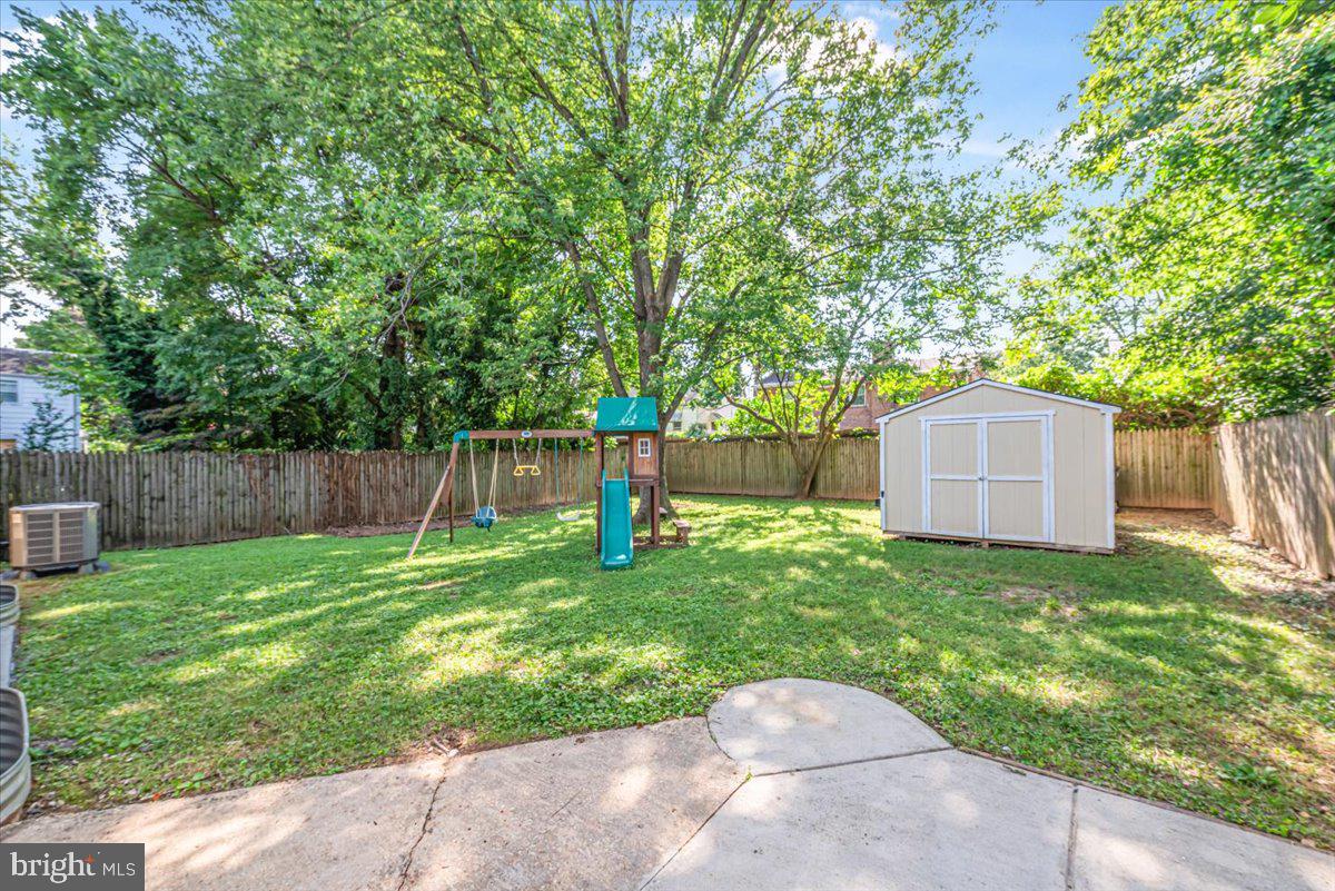 10112 Dallas Avenue Silver Spring, MD 20901 - Photo 27 of 32 a backyard with wooden fence and a large tree