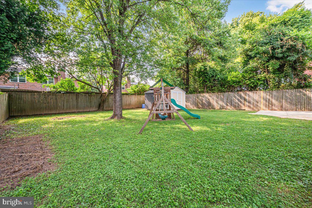 10112 Dallas Avenue Silver Spring, MD 20901 - Photo 28 of 32 a view of a backyard with a slide and a tree