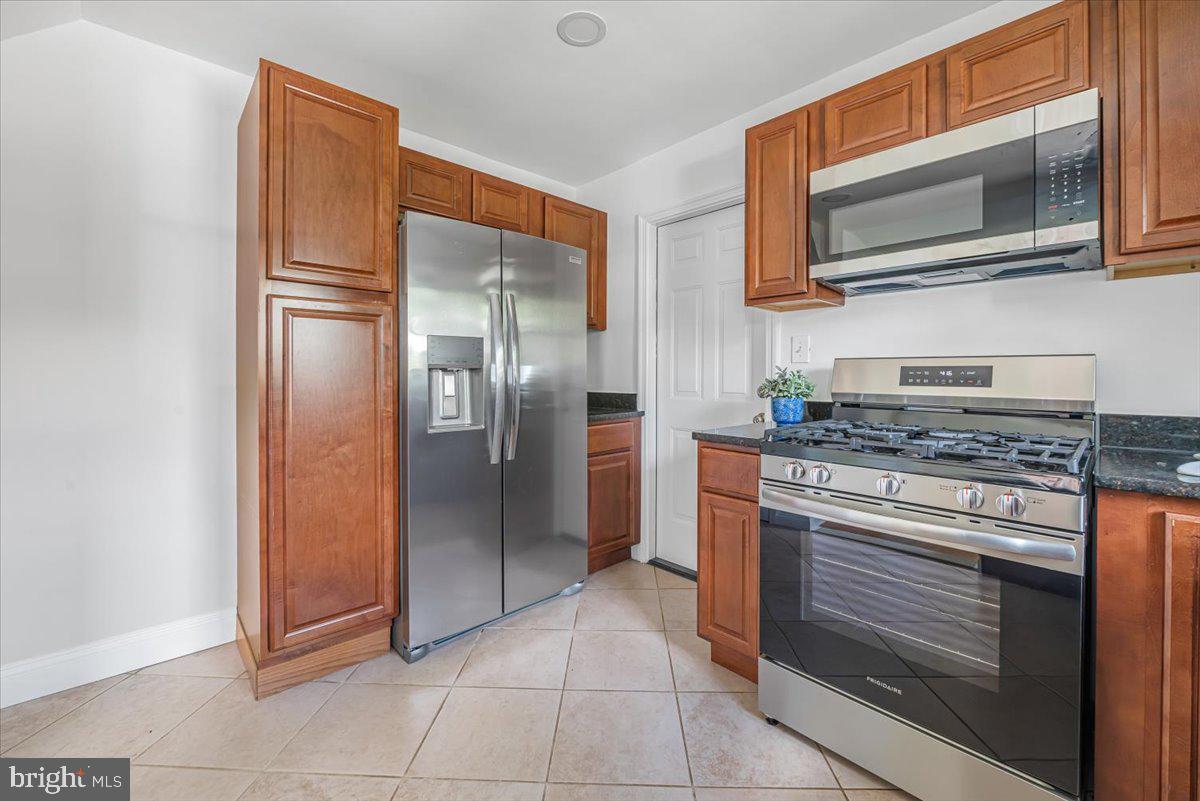 10112 Dallas Avenue Silver Spring, MD 20901 - Photo 8 of 32 a kitchen with stainless steel appliances granite countertop a refrigerator and a stove top oven
