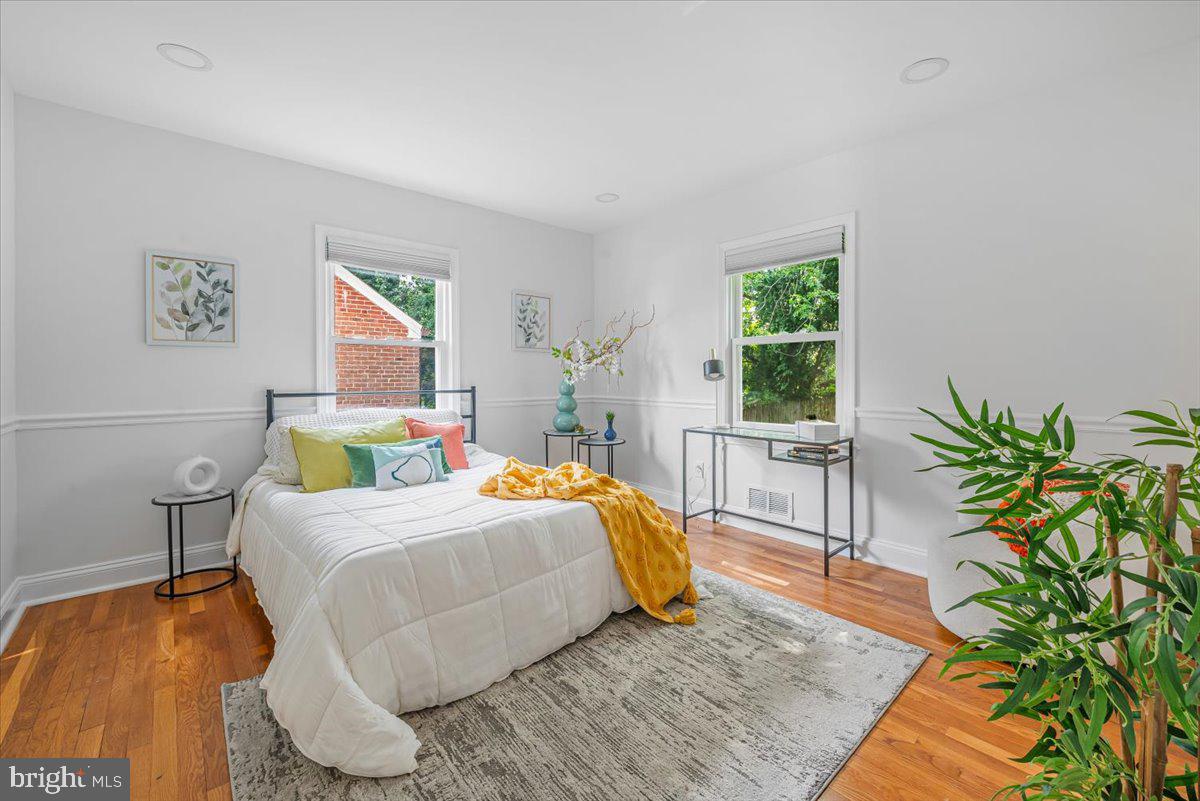 10112 Dallas Avenue Silver Spring, MD 20901 - Photo 9 of 32 a bedroom with a bed windows and a potted plant