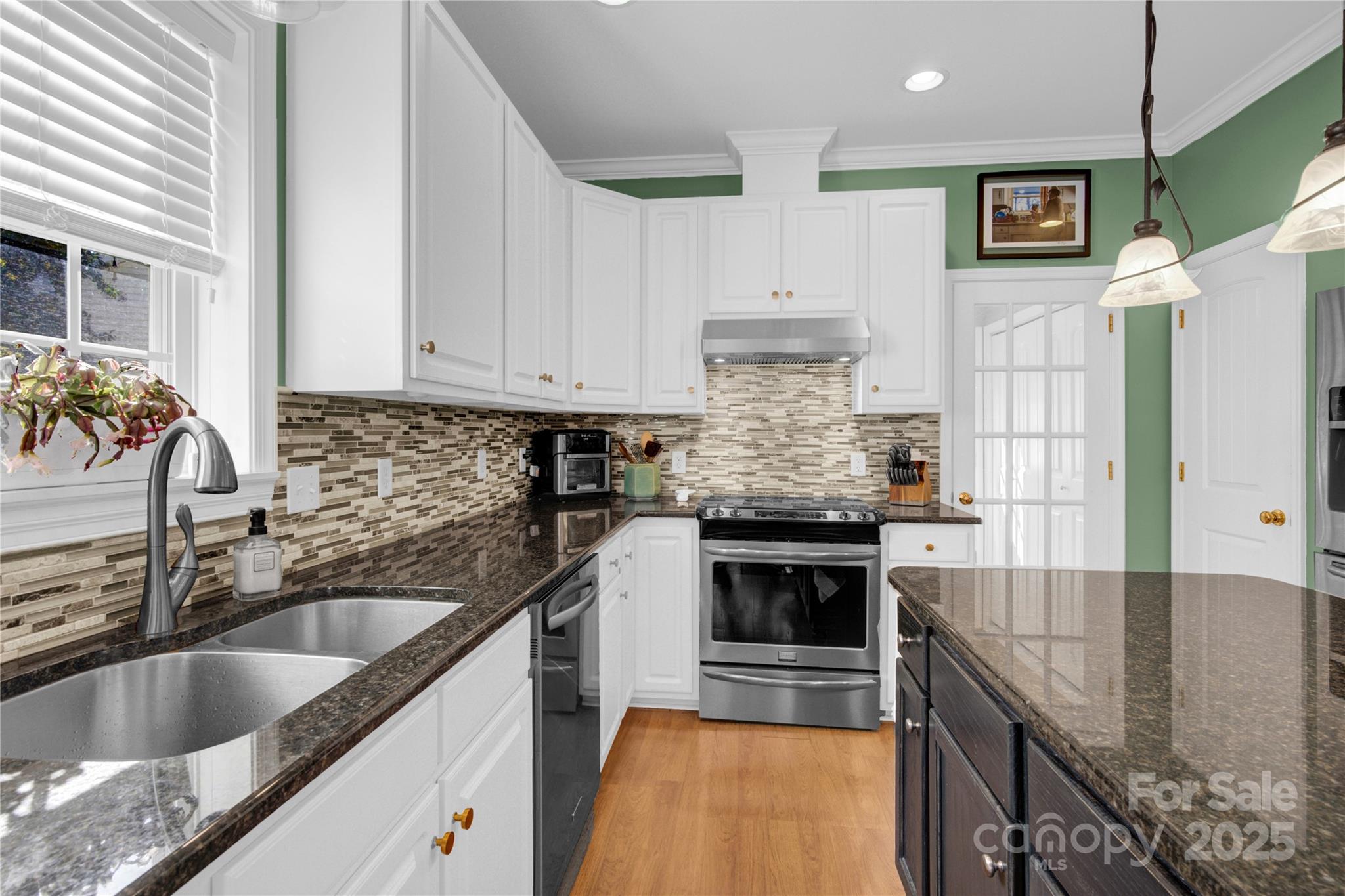 2441 27th Ave Circle Northeast Hickory, NC 28601 - Photo 26 of 45 a kitchen with stainless steel appliances granite countertop a sink stove and refrigerator