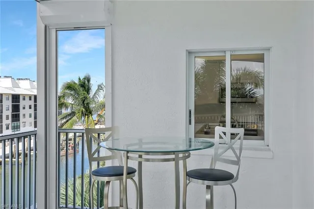 a balcony with furniture and a potted plant