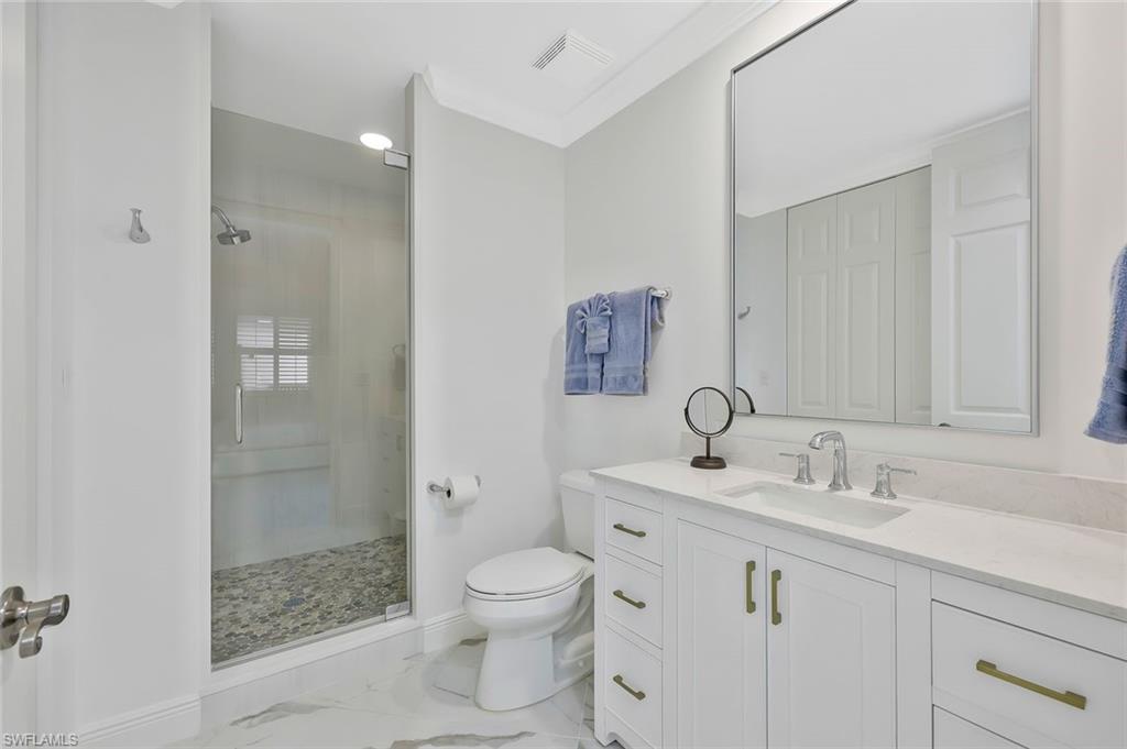400 Flagship Drive, Unit 402 Naples, FL 34108 - Photo 8 of 28 a bathroom with a sink toilet and shower