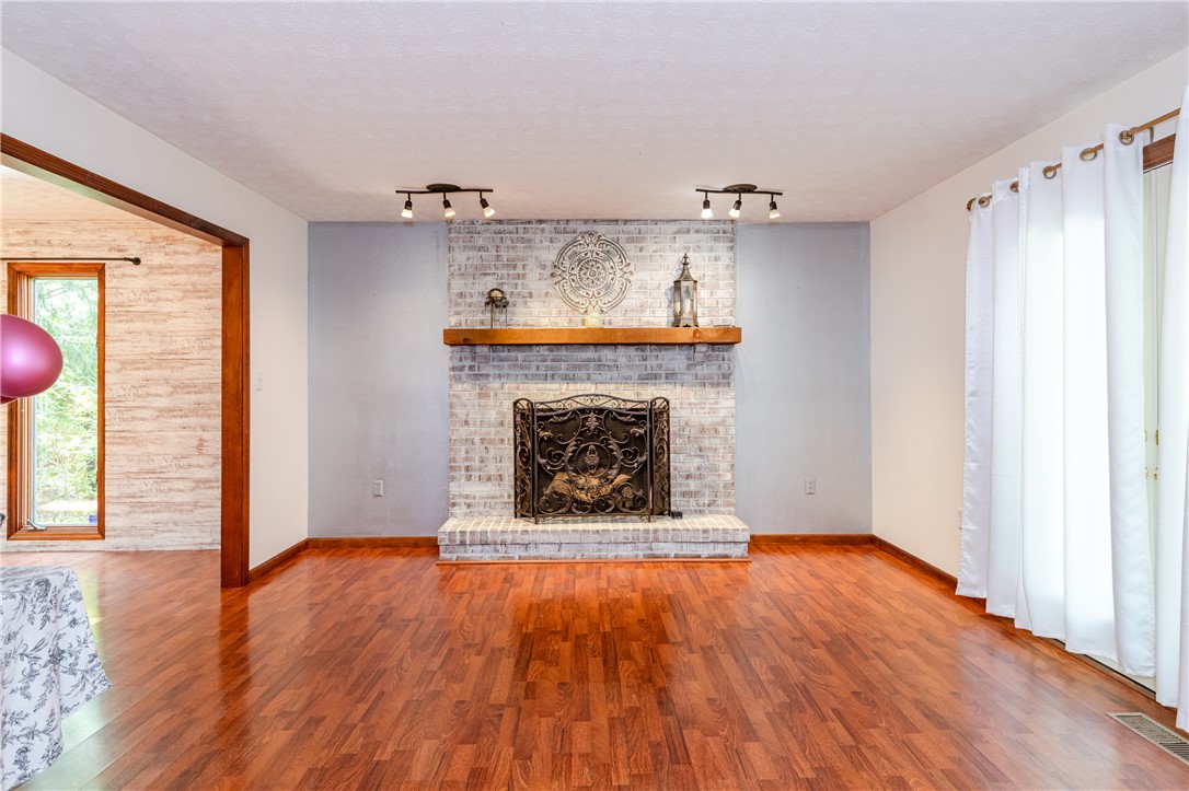 6750 Little Twin Road Germantown, OH 45327 - Photo 6 of 88 This inviting living space features gleaming wood flooring and a cozy fireplace, perfect for gatherings.