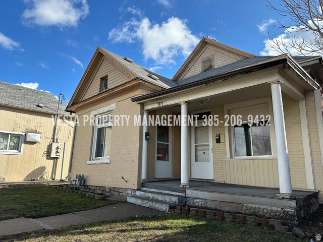471 East 22nd Street Ogden, UT 84401 - Photo 1 of 12 View of front facade with brick siding, covered porch, and a front yard