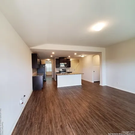 a view of large kitchen with wooden floor and electronic appliances