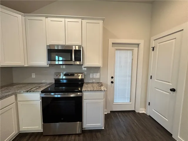a kitchen with a stove and a microwave