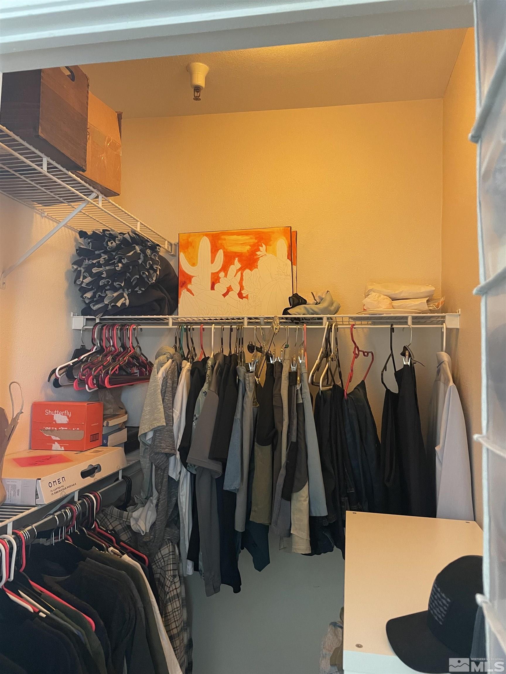 200 Talus Way, Unit 421 Reno, NV 89503 - Photo 11 of 23 a view of walk in closet with clothes and shoes