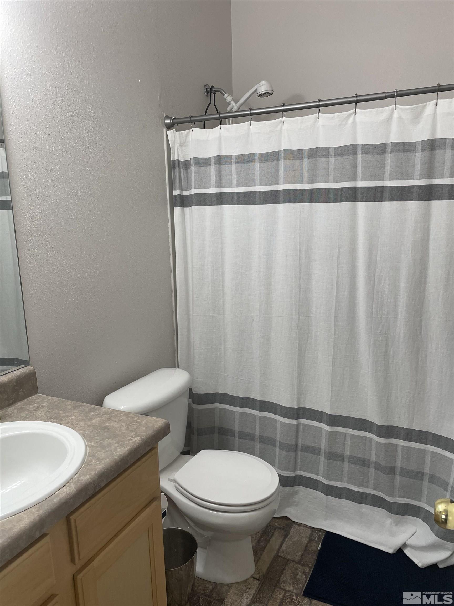 200 Talus Way, Unit 421 Reno, NV 89503 - Photo 12 of 23 a bathroom with a sink a toilet and a mirror