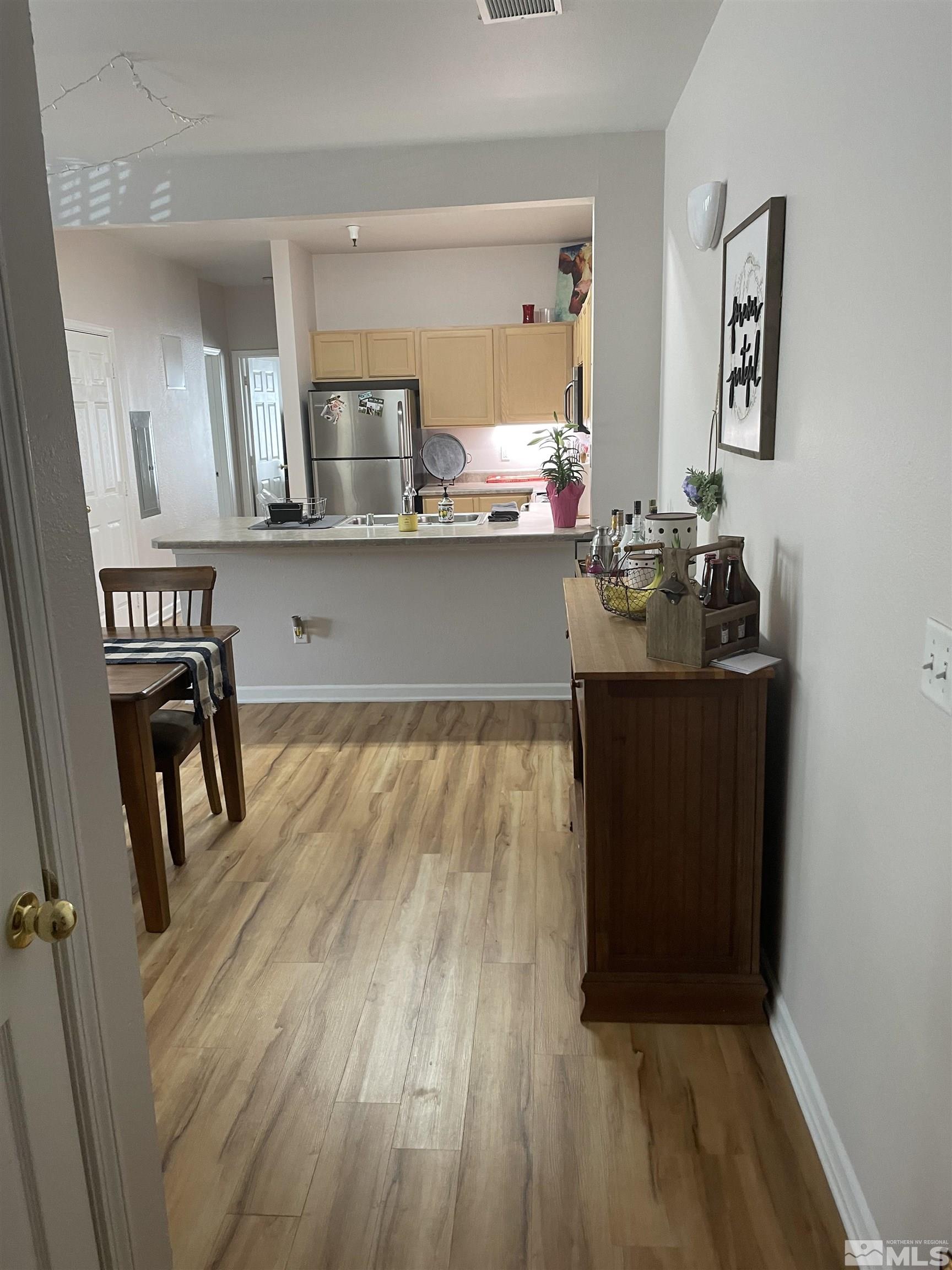200 Talus Way, Unit 421 Reno, NV 89503 - Photo 3 of 23 a kitchen with granite countertop a stove and cabinets