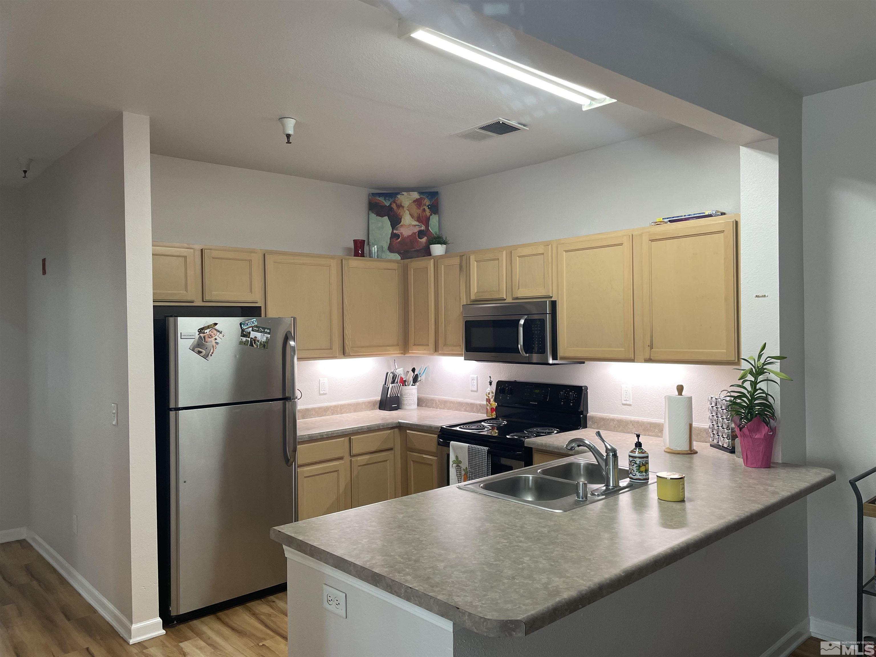 200 Talus Way, Unit 421 Reno, NV 89503 - Photo 8 of 23 a kitchen with refrigerator and microwave