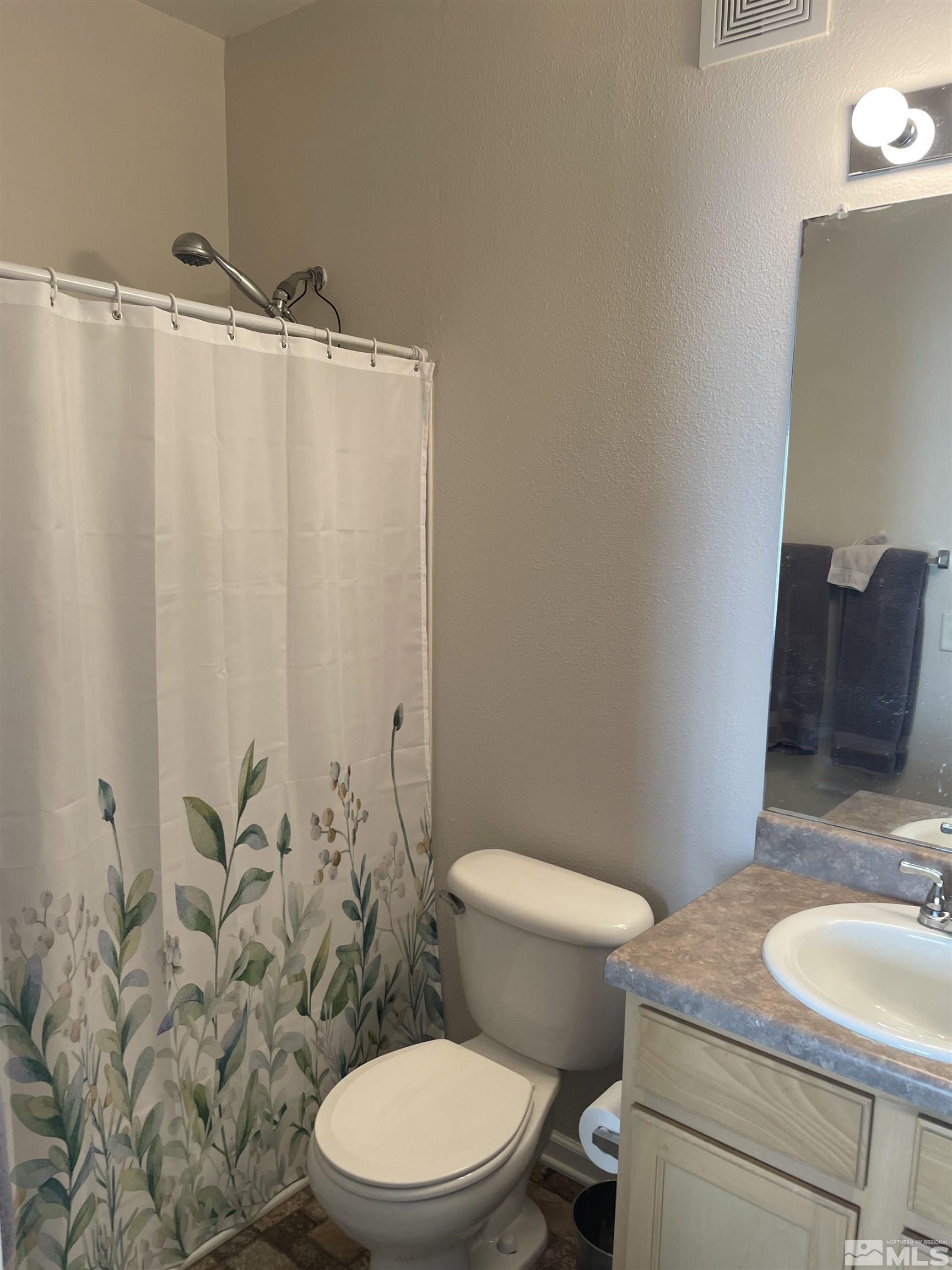 200 Talus Way, Unit 421 Reno, NV 89503 - Photo 9 of 23 a white toilet sitting next to a bathroom sink