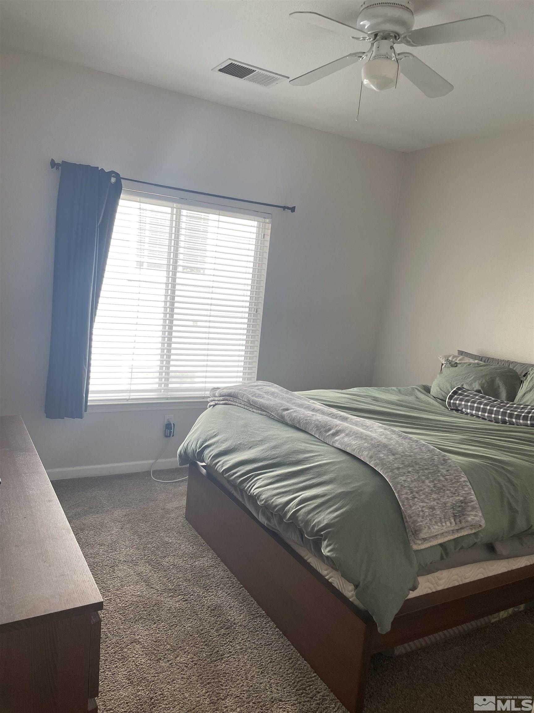 200 Talus Way, Unit 421 Reno, NV 89503 - Photo 10 of 23 a bedroom with a large bed and a chandelier