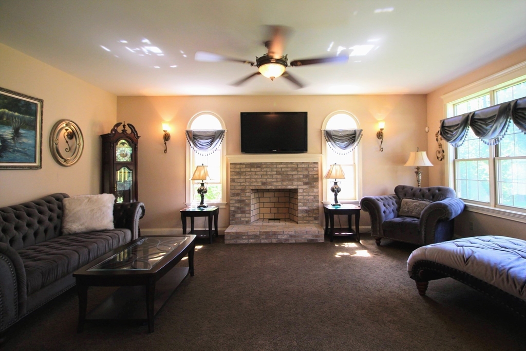 5 Gableview Lane Southwick, MA 01077 - Photo 19 of 41 a living room with furniture a fireplace and a flat screen tv