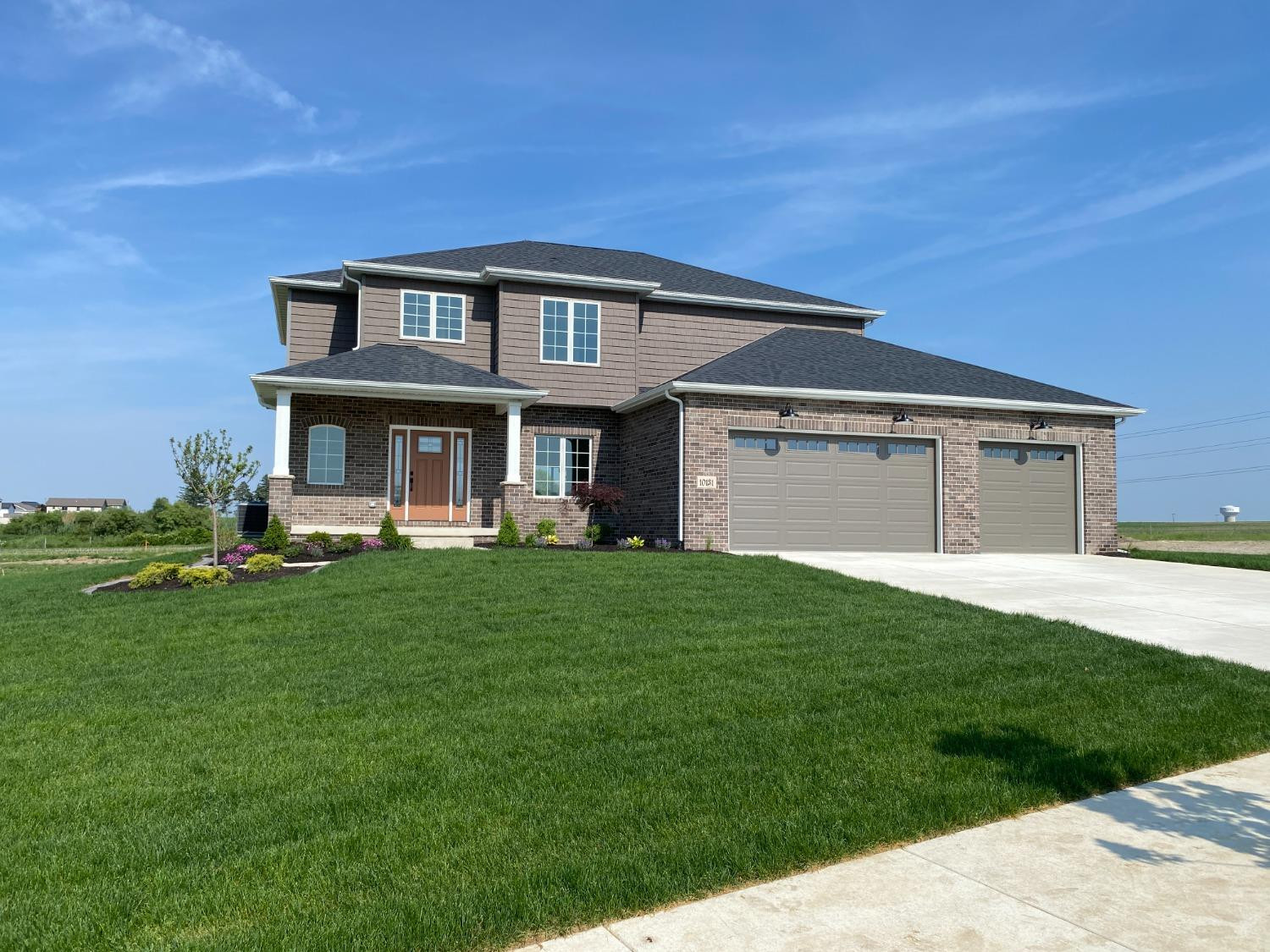 10131 Springlake Road St. John, IN 46373 - Photo 1 of 13 a front view of a house with a garden