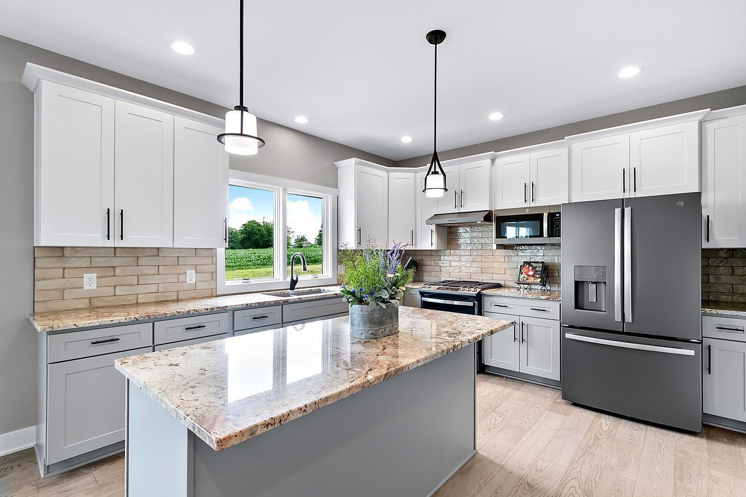 10131 Springlake Road St. John, IN 46373 - Photo 5 of 13 a kitchen with stainless steel appliances granite countertop a refrigerator a stove a sink and a refrigerator