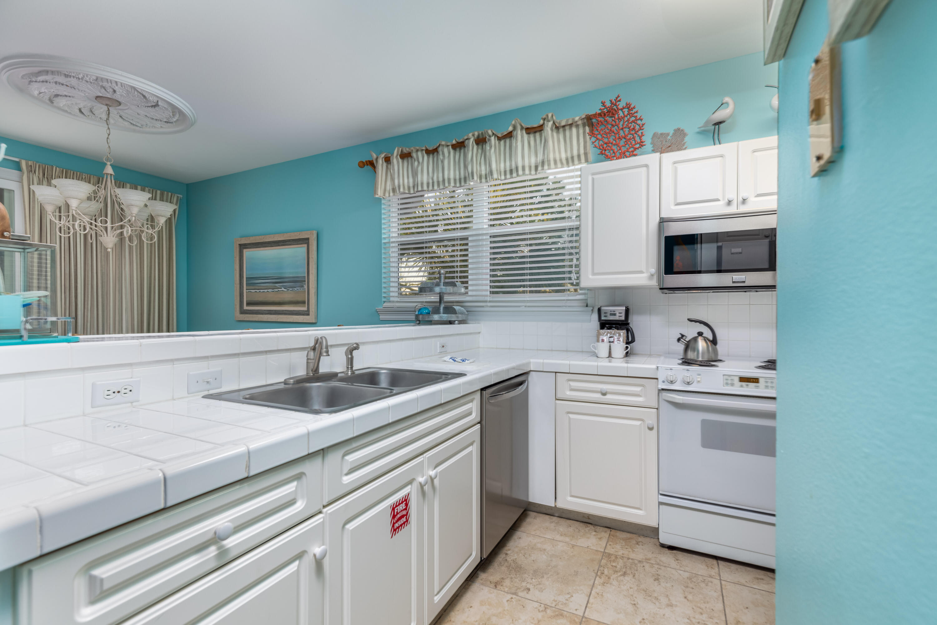 8537 Turnberry Court, Unit 8537 Miramar Beach, FL 32550 - Photo 4 of 18 a kitchen with a sink stove and cabinets