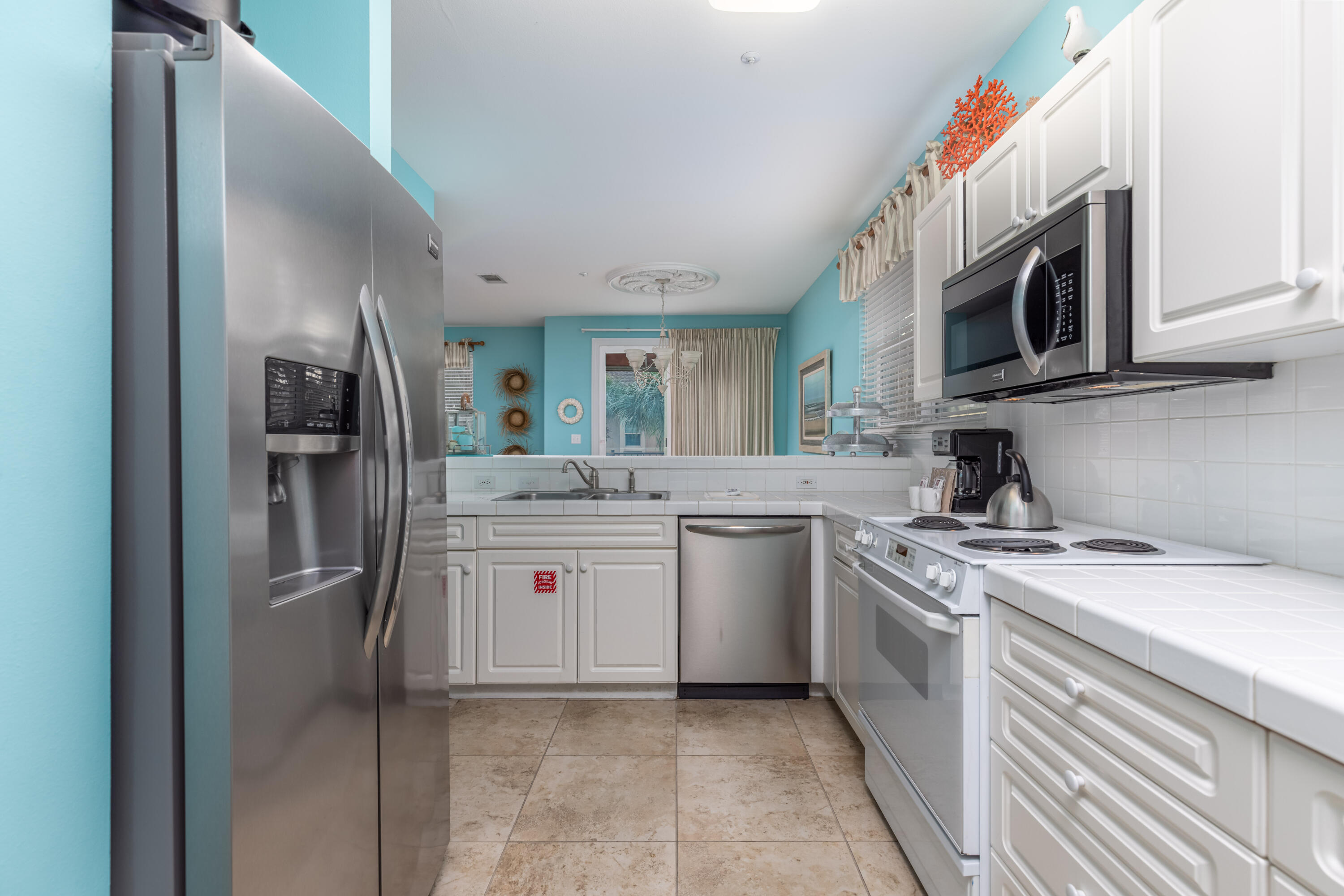8537 Turnberry Court, Unit 8537 Miramar Beach, FL 32550 - Photo 5 of 18 a kitchen with stainless steel appliances granite countertop a refrigerator and a stove top oven