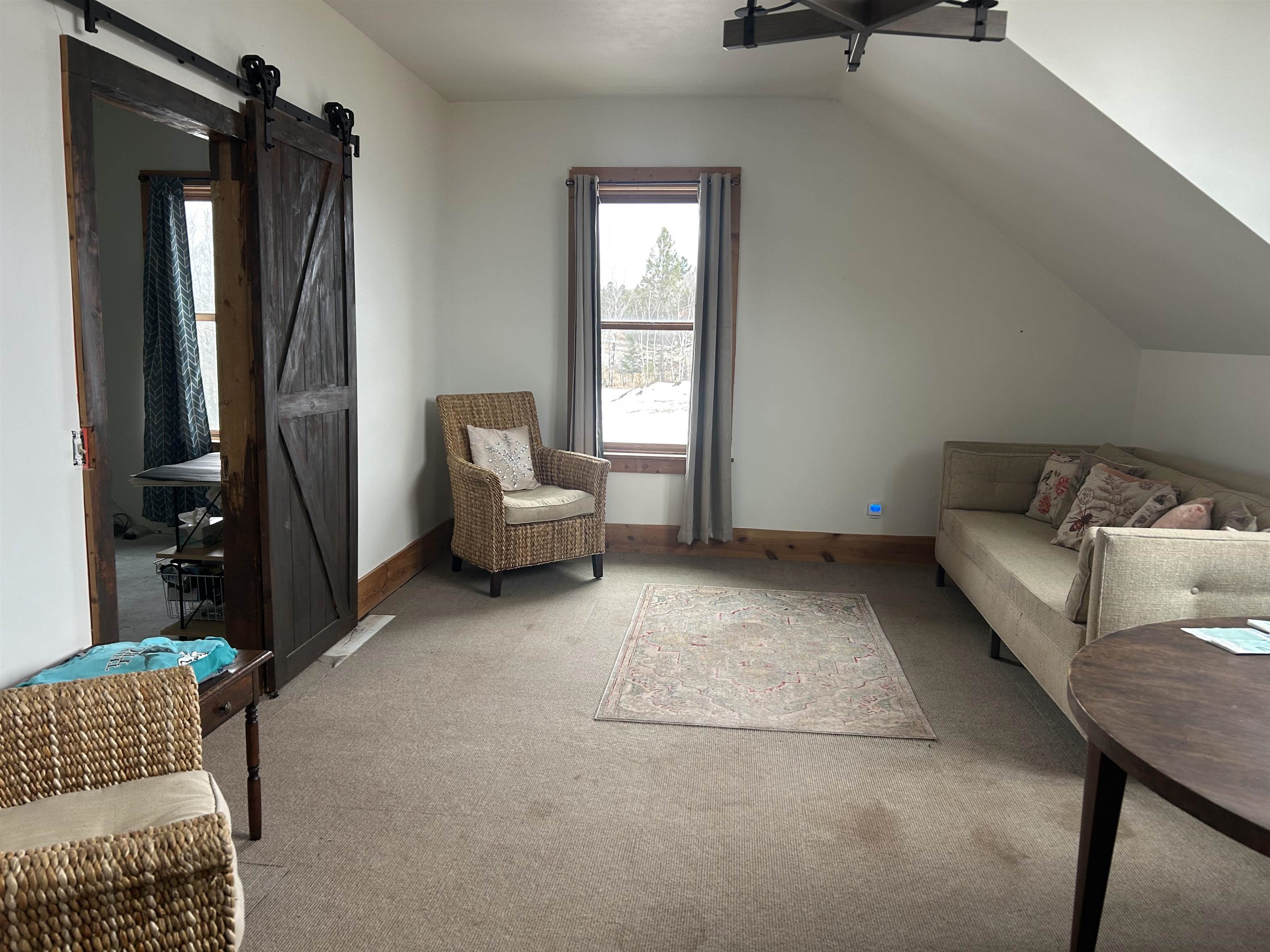 59460 Main Street Mason, WI 54856 - Photo 2 of 18 Interior space with lofted ceiling, light colored carpet, and a barn door