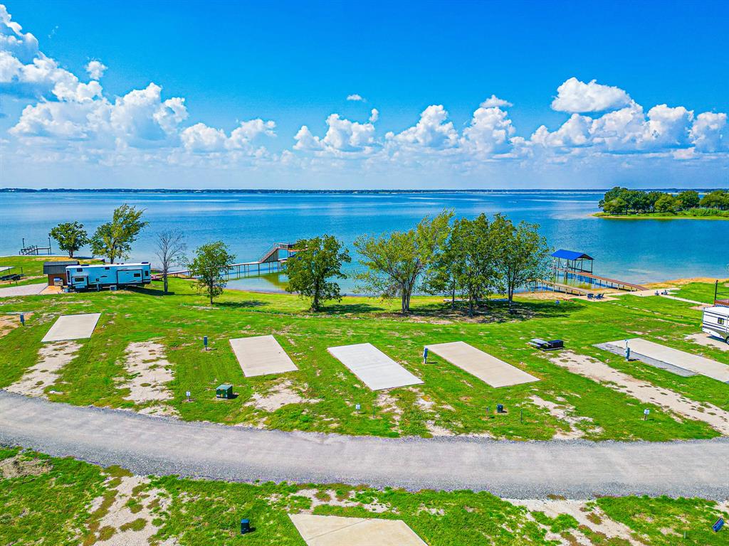 Lot 34 Waterfront Road Kerens, TX 75144 - Photo 12 of 39 a view of a building and a yard with swimming pool