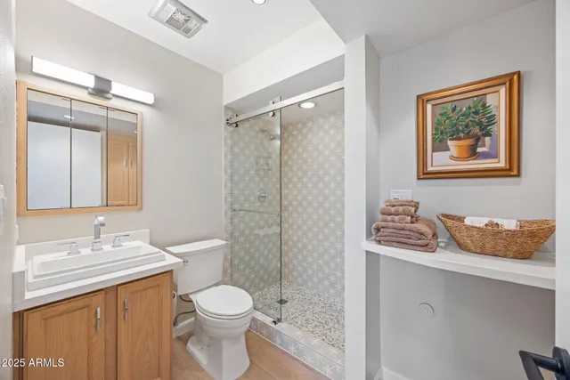 a bathroom with a toilet sink and shower