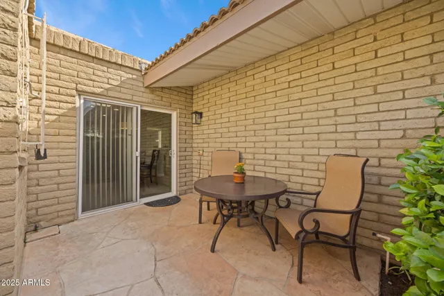 a backyard of a house with table and chairs