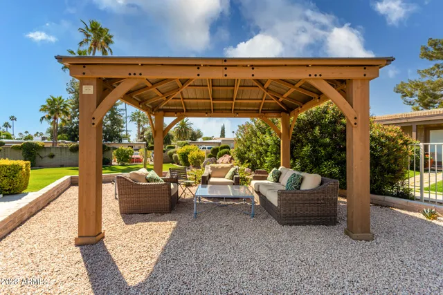 a view of patio with couple of couches and potted plants