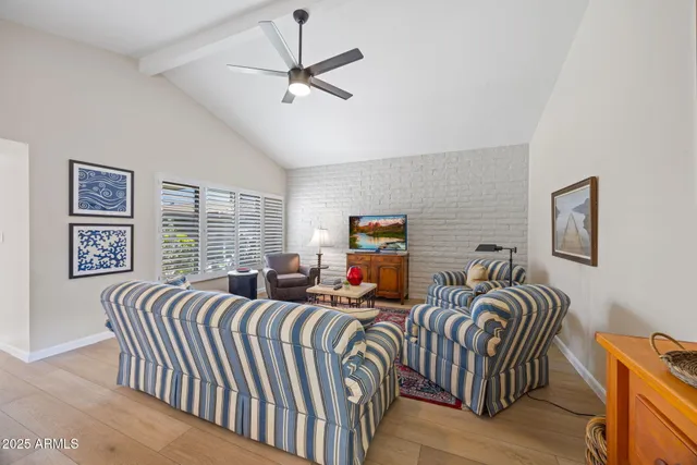 a bedroom with two beds and a chandelier