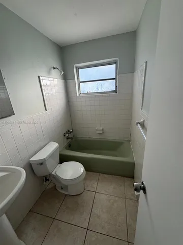 a bathroom with a toilet and a bathtub