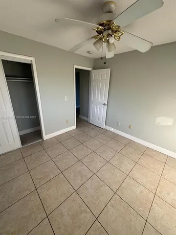 a view of entryway with a chandelier fan