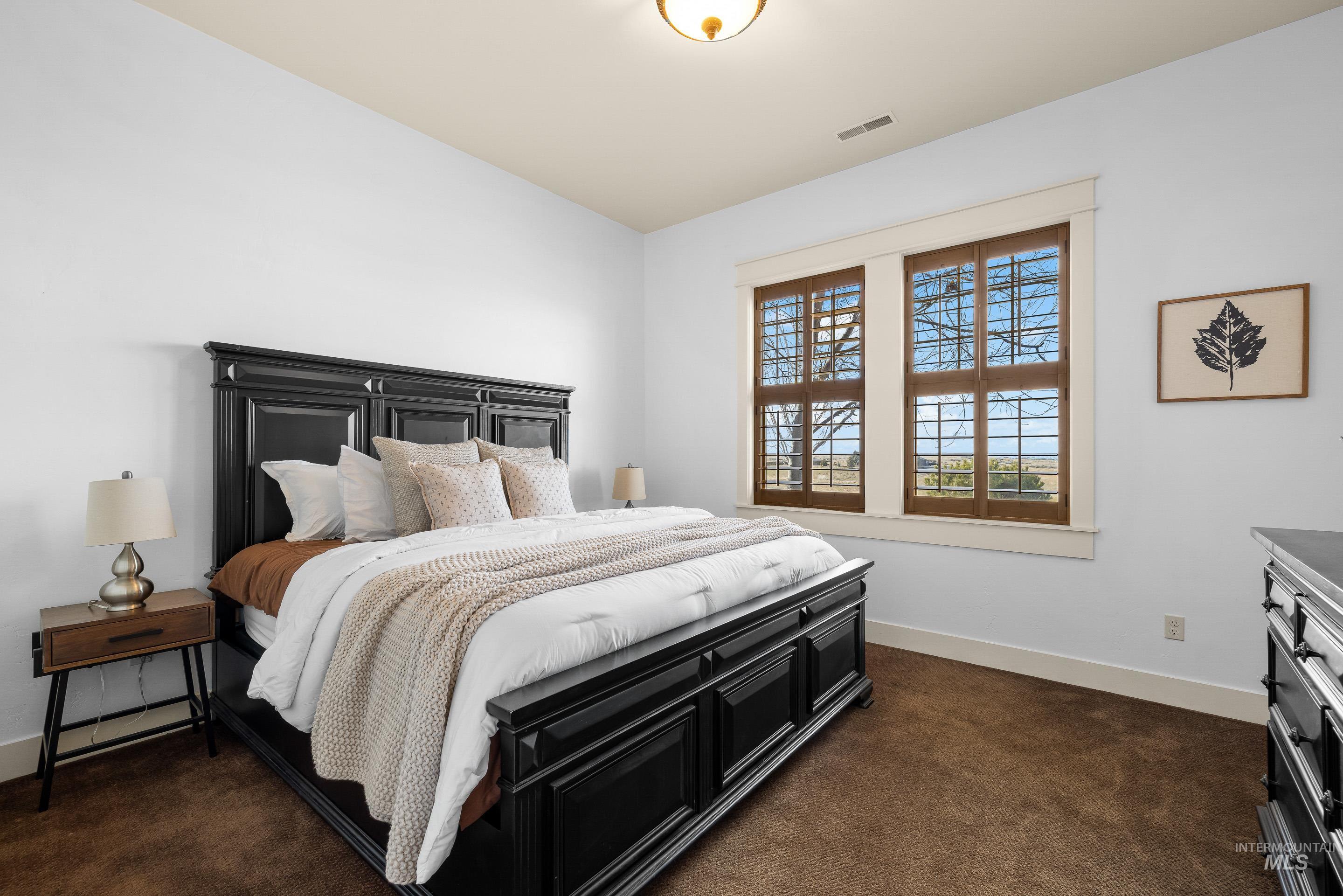 7521 North Grand Ridge Lane Eagle, ID 83616 - Photo 37 of 50 Bedroom with dark carpet and baseboards