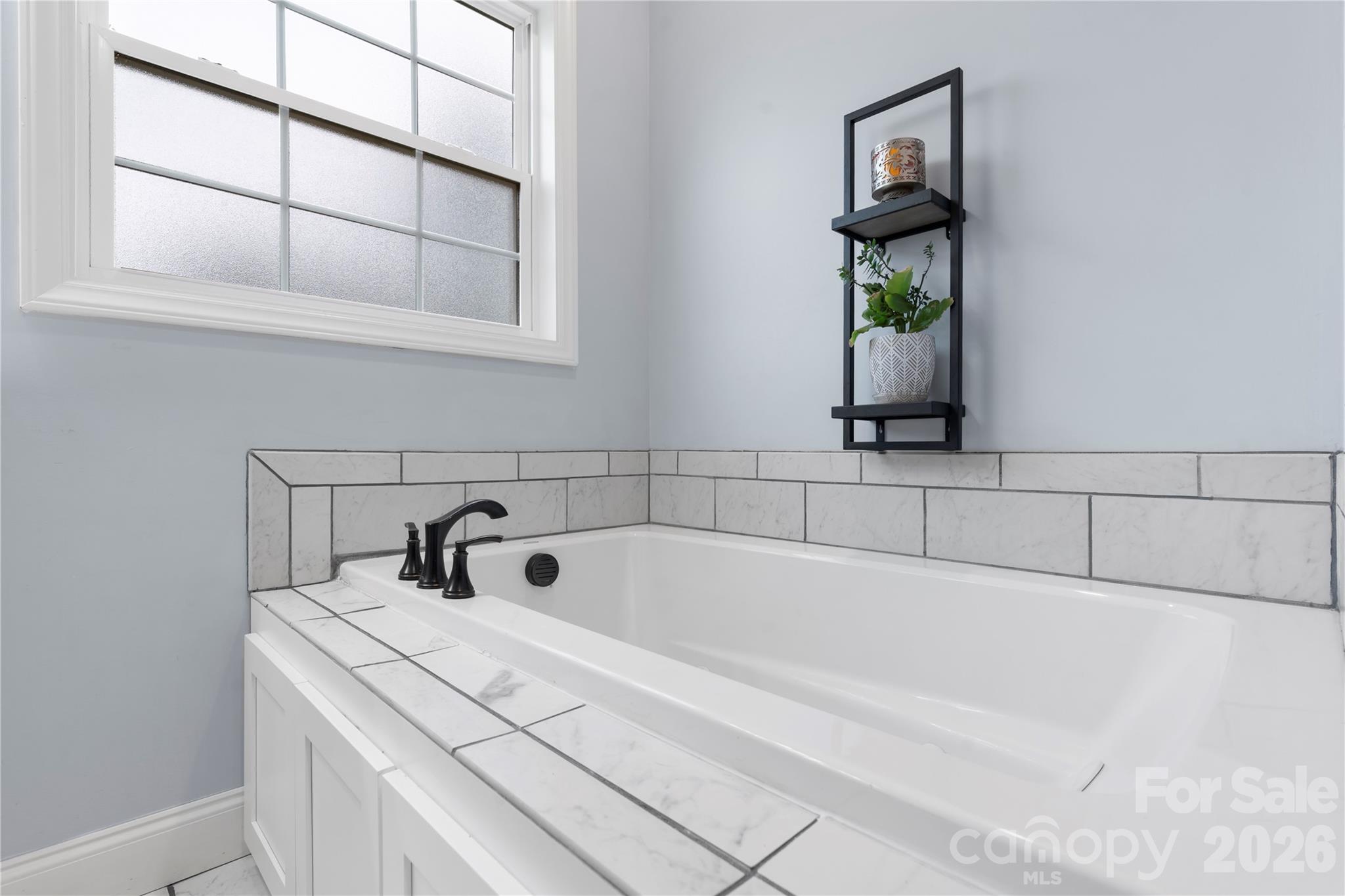 111 Pinewood Road Granite Falls, NC 28630 - Photo 16 of 33 a bathroom with a bathtub and window