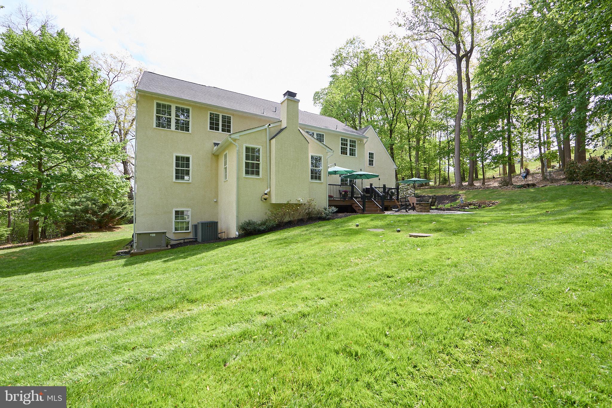 661 St Matthews Road Chester Springs, PA 19425 - Photo 58 of 64 Serene backyard retreat in lush greenery.