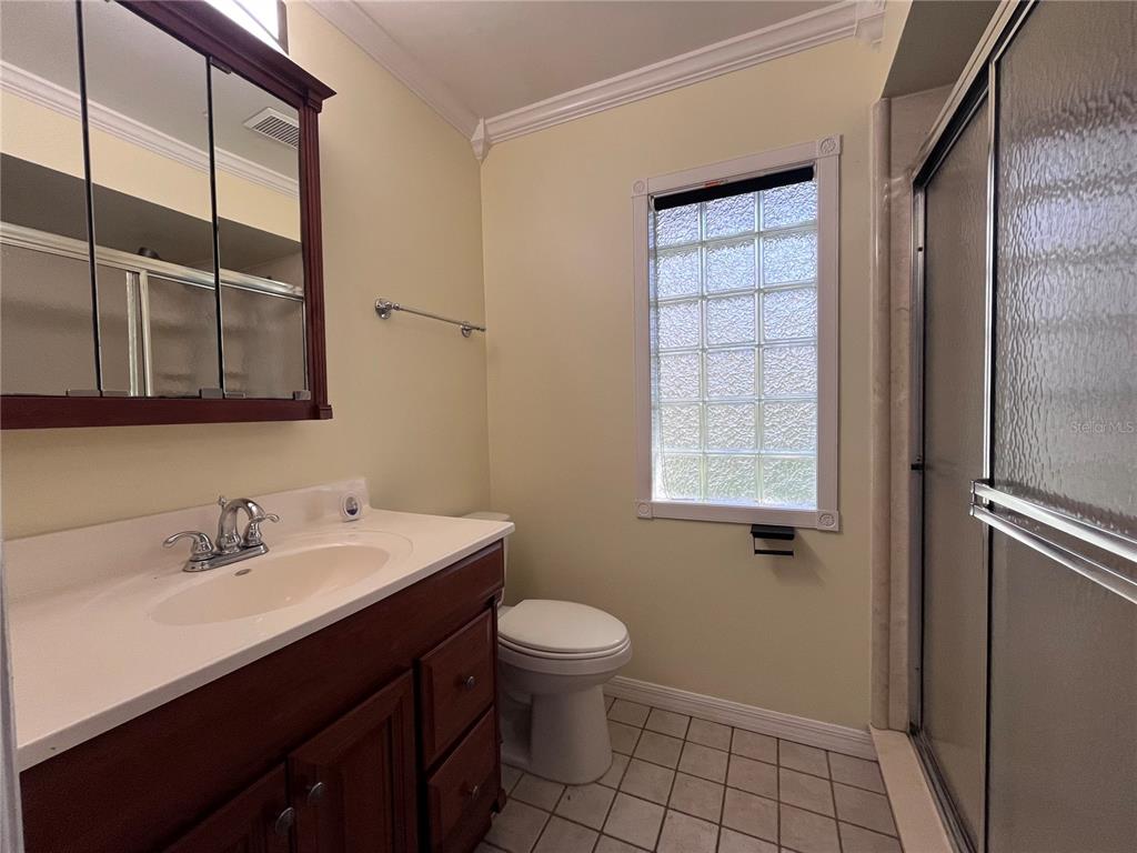 8122 Matthew Drive New Port Richey, FL 34653 - Photo 12 of 25 a bathroom with a sink a toilet and shower