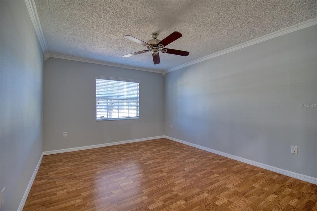 8122 Matthew Drive New Port Richey, FL 34653 - Photo 14 of 25 an empty room with windows and fan