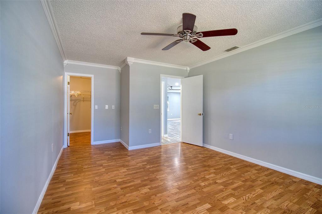 8122 Matthew Drive New Port Richey, FL 34653 - Photo 15 of 25 a view of a livingroom with a ceiling fan and wooden floor