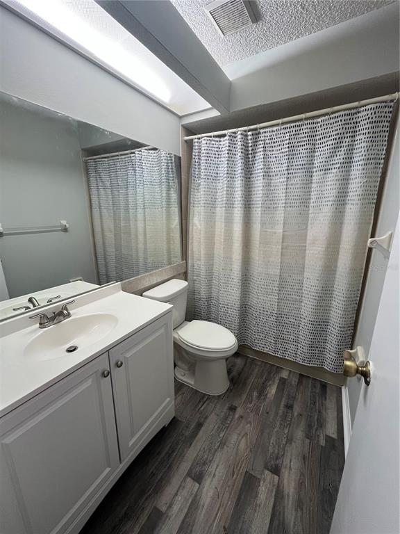 8122 Matthew Drive New Port Richey, FL 34653 - Photo 19 of 25 a bathroom with a sink a toilet and shower