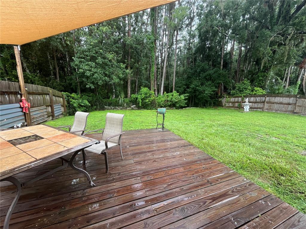 8122 Matthew Drive New Port Richey, FL 34653 - Photo 20 of 25 a view of a wooden deck and a patio