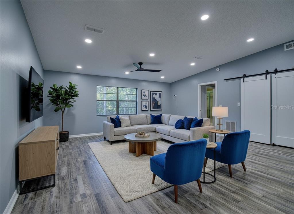 8122 Matthew Drive New Port Richey, FL 34653 - Photo 5 of 25 a living room with furniture potted plant and a window