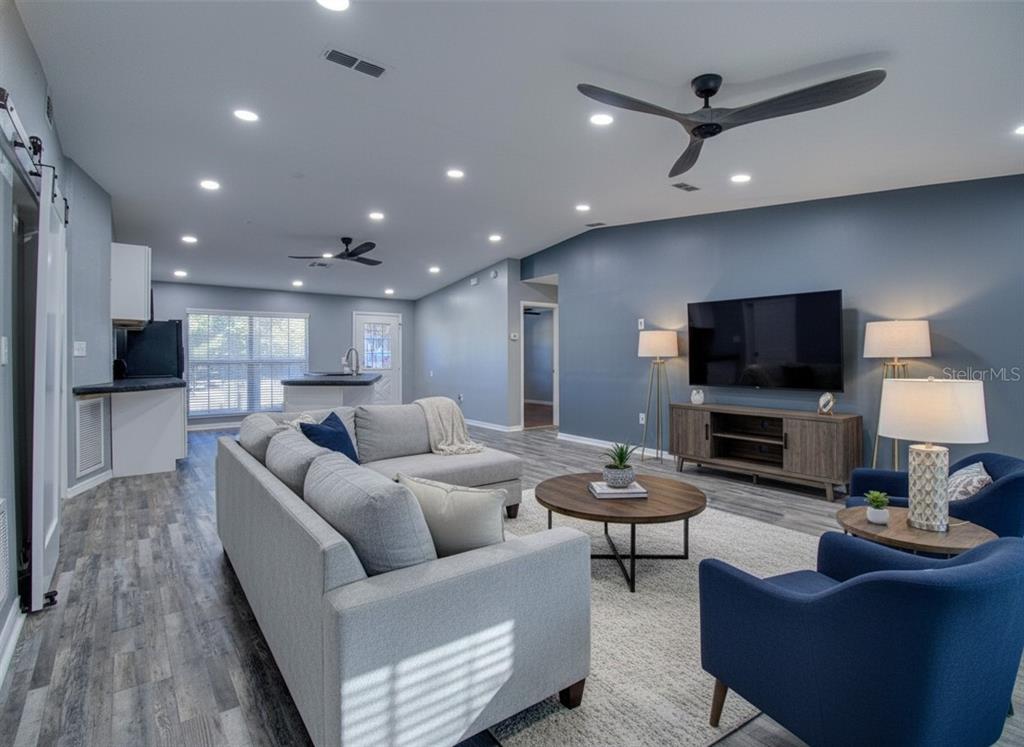 8122 Matthew Drive New Port Richey, FL 34653 - Photo 7 of 25 a living room with furniture and a flat screen tv