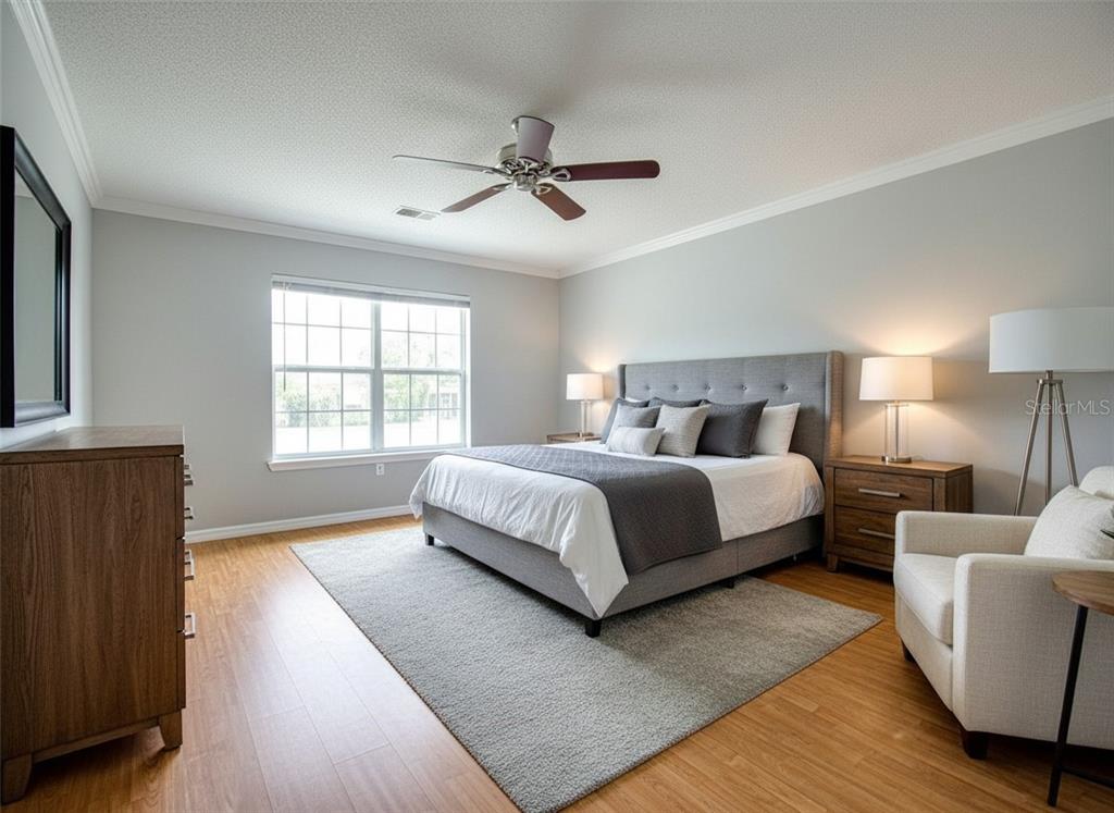 8122 Matthew Drive New Port Richey, FL 34653 - Photo 9 of 25 a bedroom with a large bed wooden floor and window