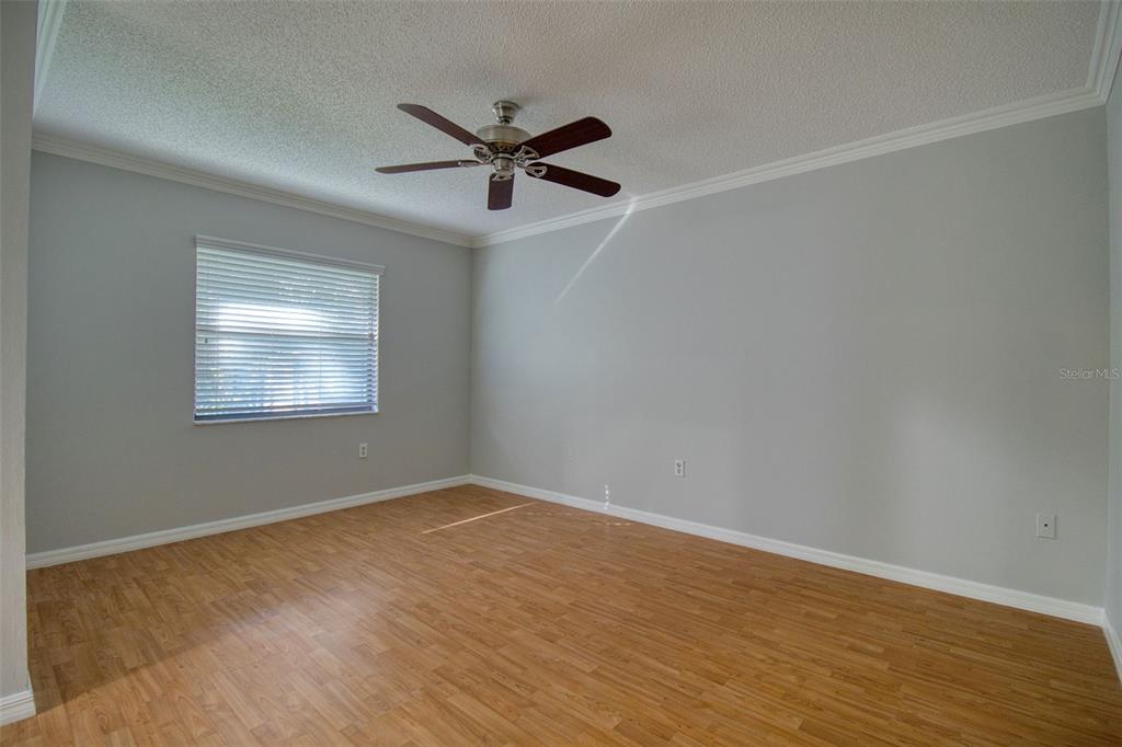 8122 Matthew Drive New Port Richey, FL 34653 - Photo 10 of 25 a view of an empty room with wooden floor and a window