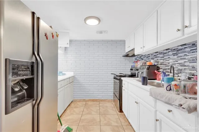 a kitchen with stainless steel appliances a refrigerator and a sink