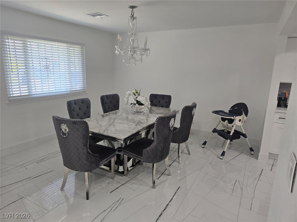 3153 Downing Place Las Vegas, NV 89121 - Photo 3 of 7 Dining space featuring a chandelier and light marble finish floors