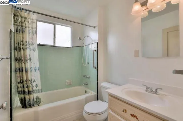 a bathroom with a bathtub shower sink vanity and toilet