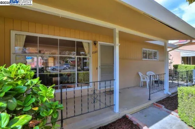 a view of a patio with table and chairs and potted plants