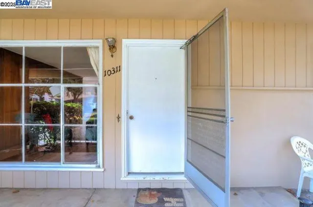 a view of a room with door wooden shelves and entryway