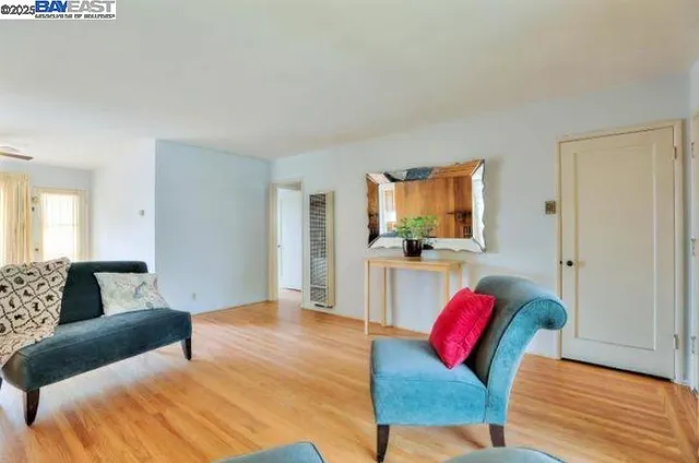 a bedroom with a bed a couch and a flat screen tv